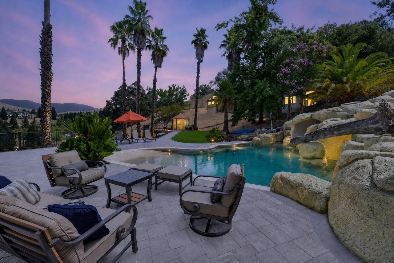 Twilight view of resort pool and patio at 73 Blackhawk Club Ct in Blackhawk California, listed by Joujou Chawla.