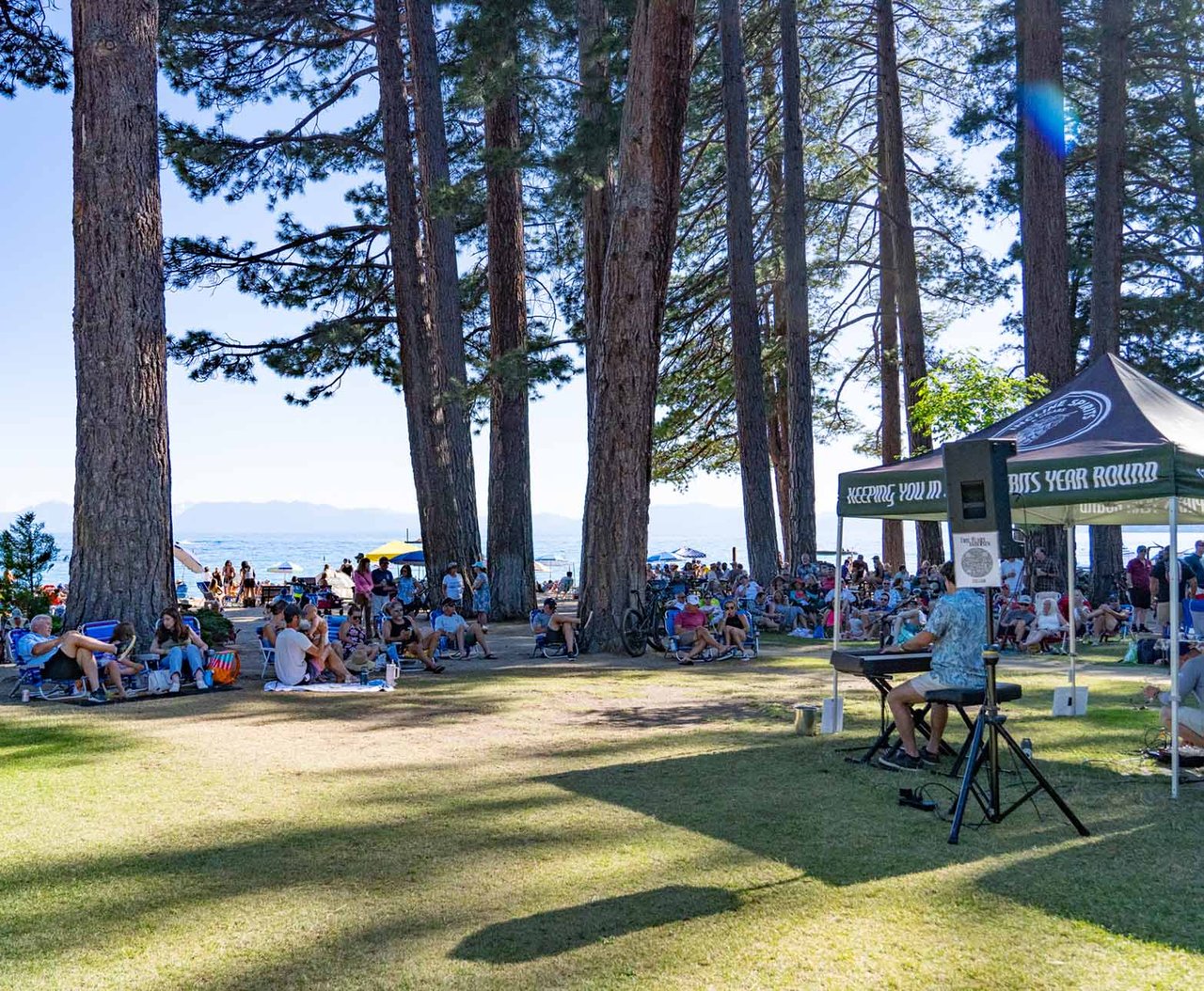 Crowd enjoying live music on the beach in Incline Village at sunset