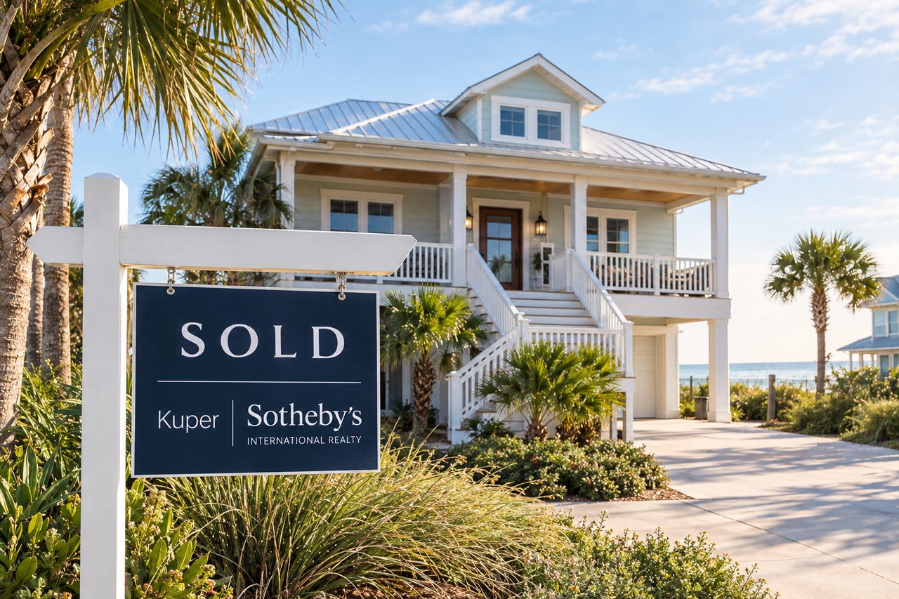 Coastal two-story home with a covered porch and a prominent SOLD real estate sign.