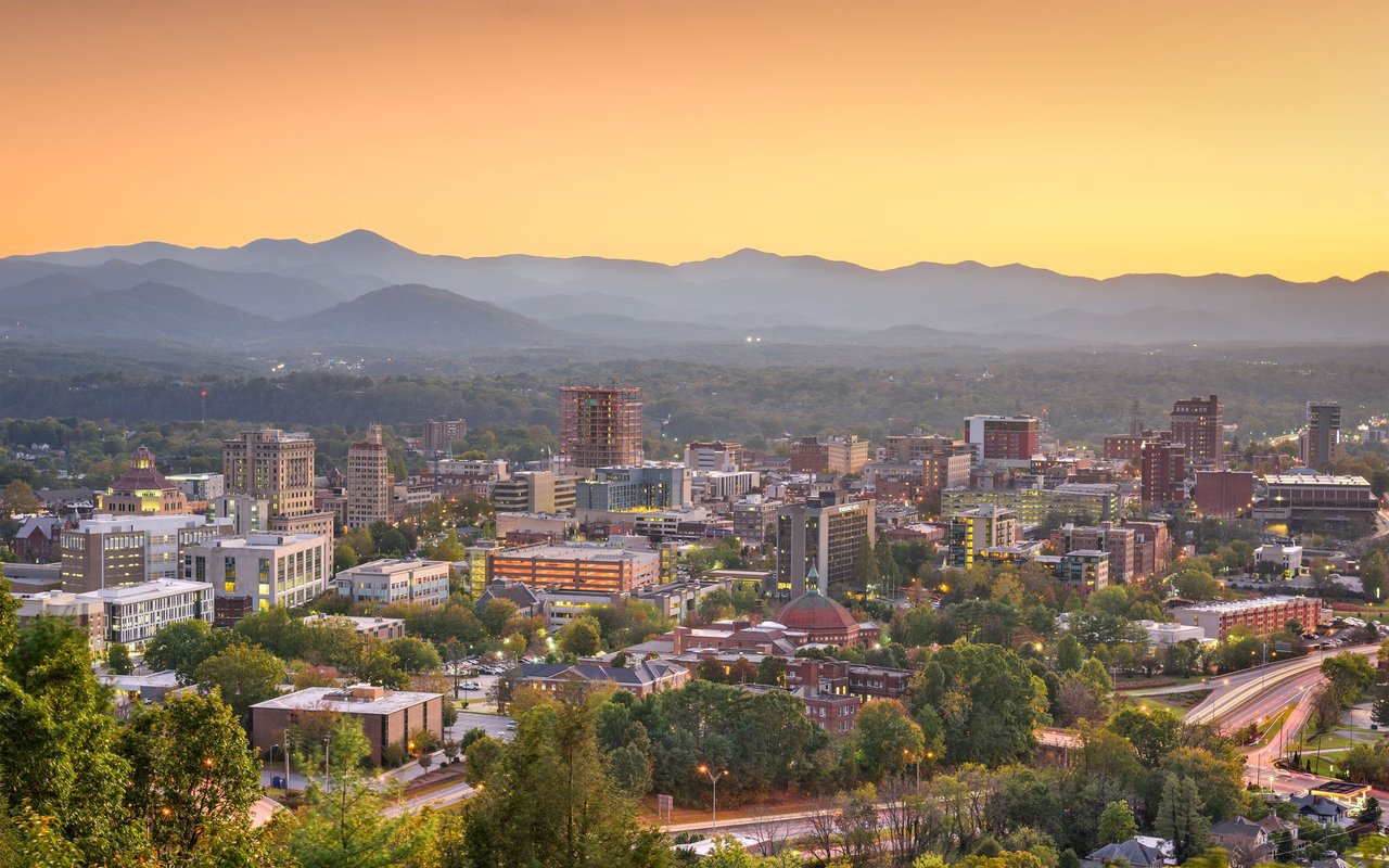 Downtown Asheville and the Blue Ridge Mountains at golden hour.