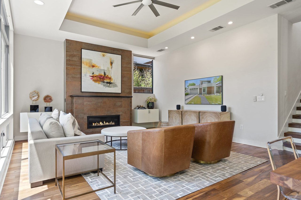 Living room media seating area with hardwood floors at 34 Margranita Crescent, Tarrytown, Austin, TX.