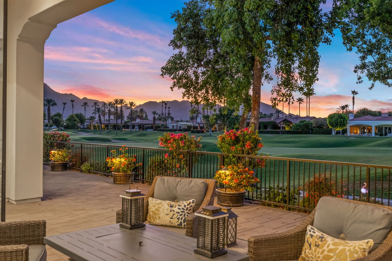 Covered patio at sunset overlooking the fourth fairway at The Citrus Club in La Quinta, California, with the Santa Rosa Mountains beyond