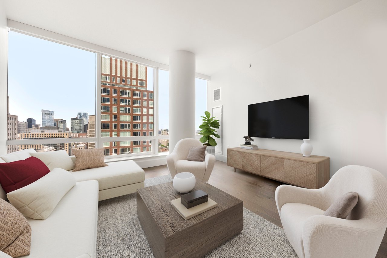 Furnished living room with floor-to-ceiling windows overlooking the downtown skyline.