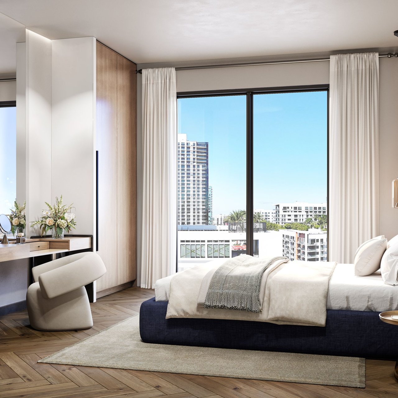 Staged bedroom with a navy bed and floor-to-ceiling windows overlooking Miami buildings.