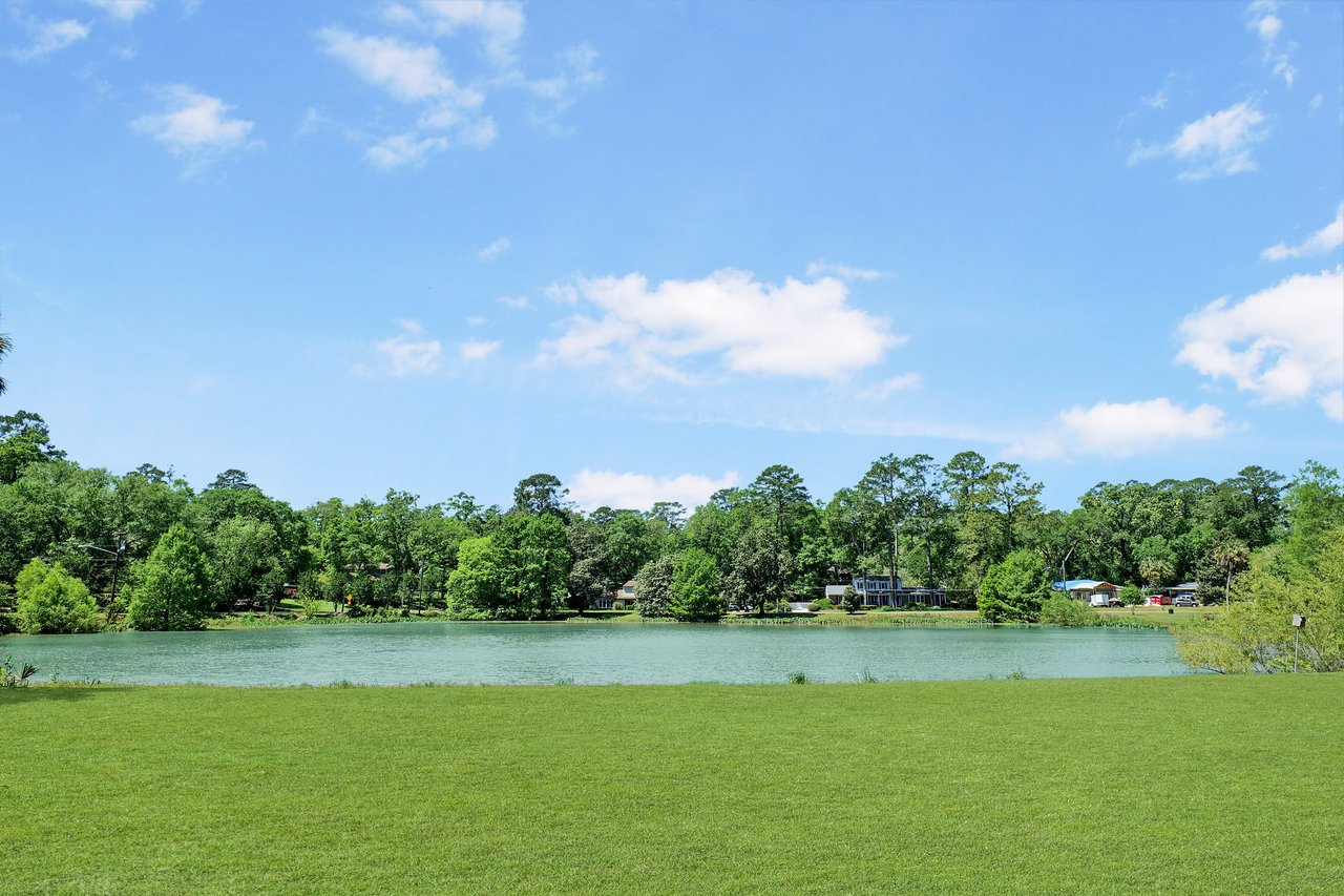 An open area with a pond and greenery, likely part of the Waverly Hills neighborhood.