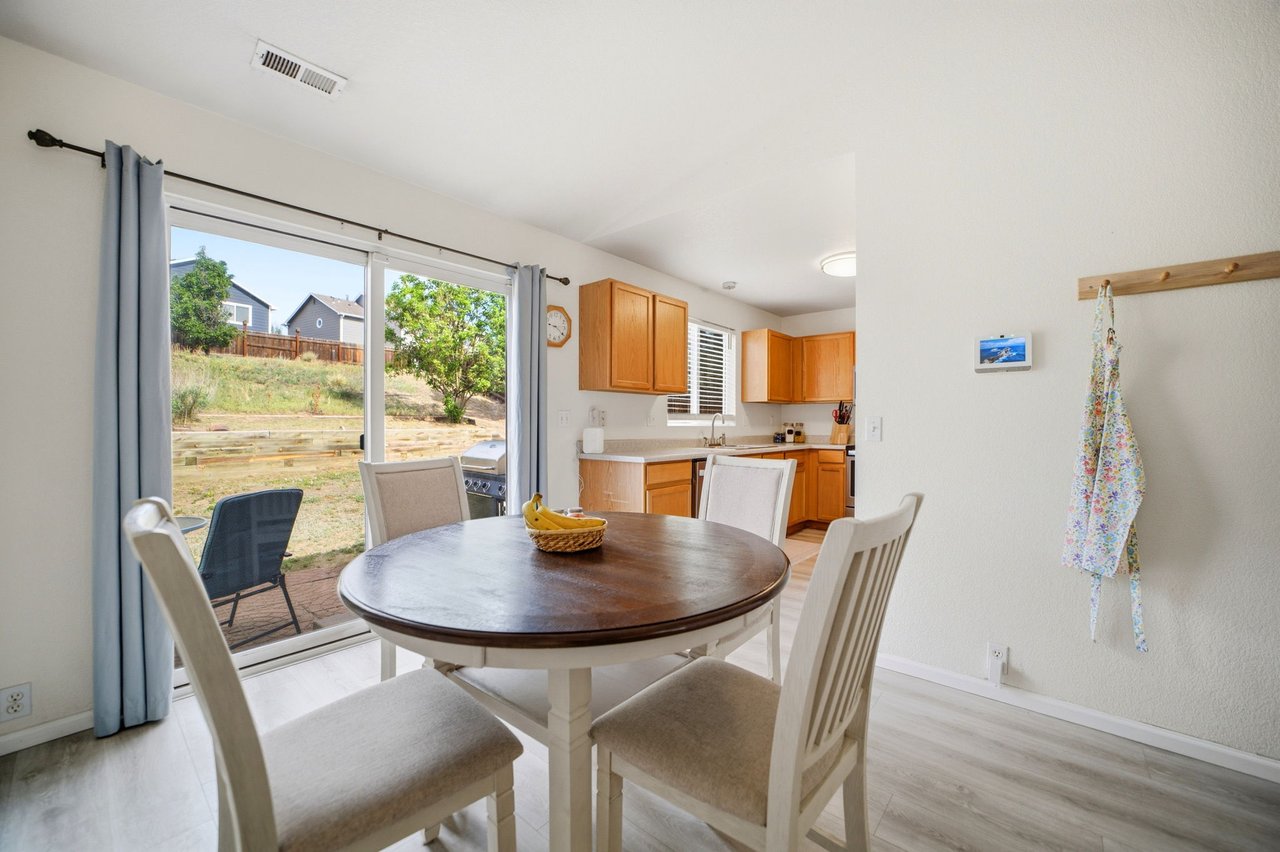 Eat-in dining area with round table and sliding glass door to the backyard patio