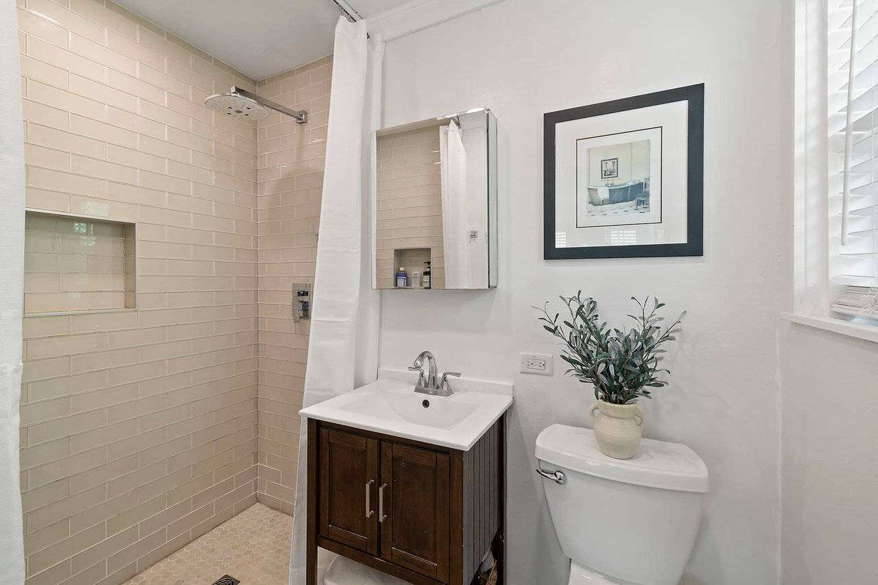 Bathroom with a tiled shower and dark wood vanity, Tarrytown, Austin.