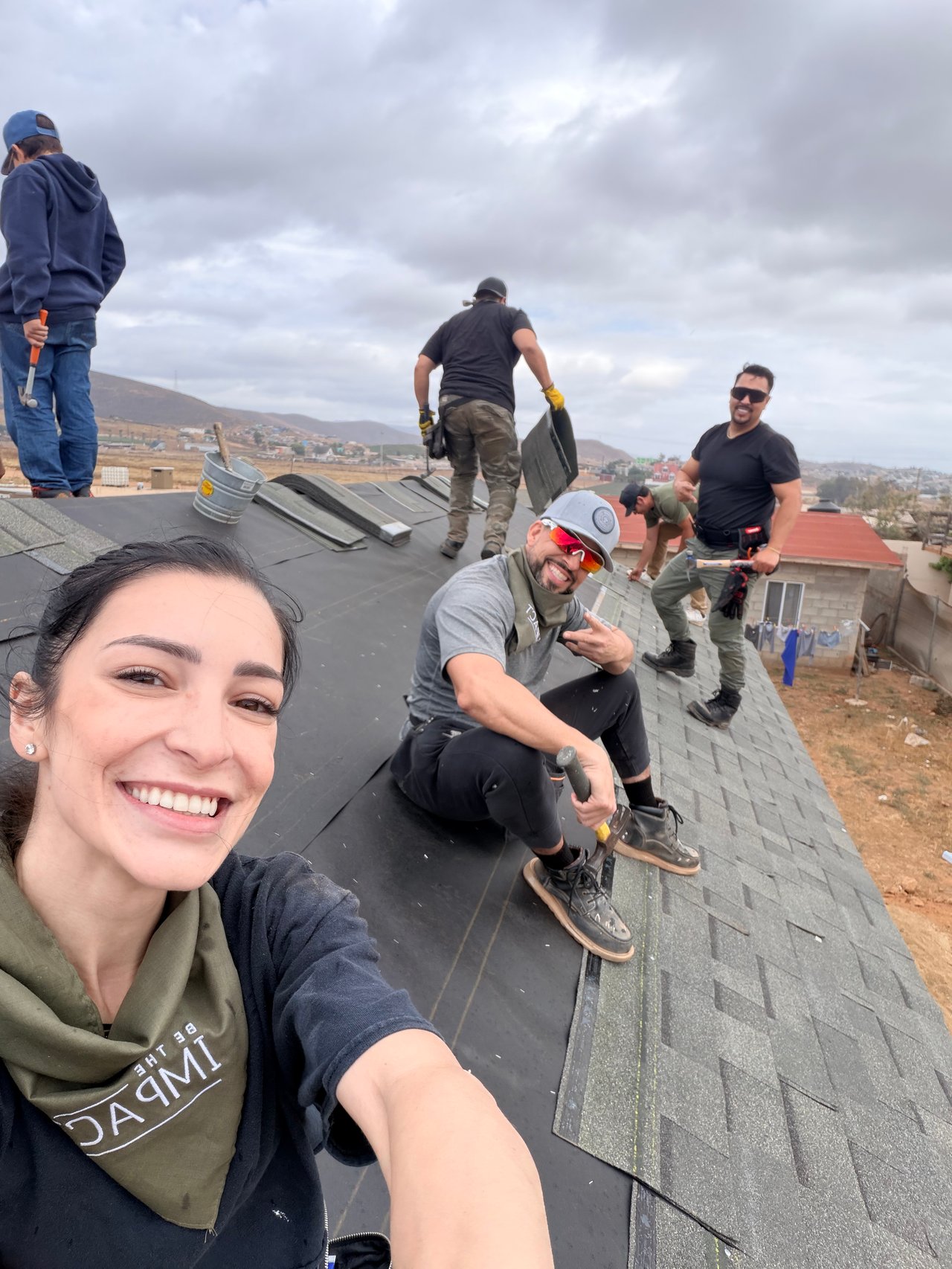 Day Two: Jade, Jerry, and others installing shingles on the roof. 
