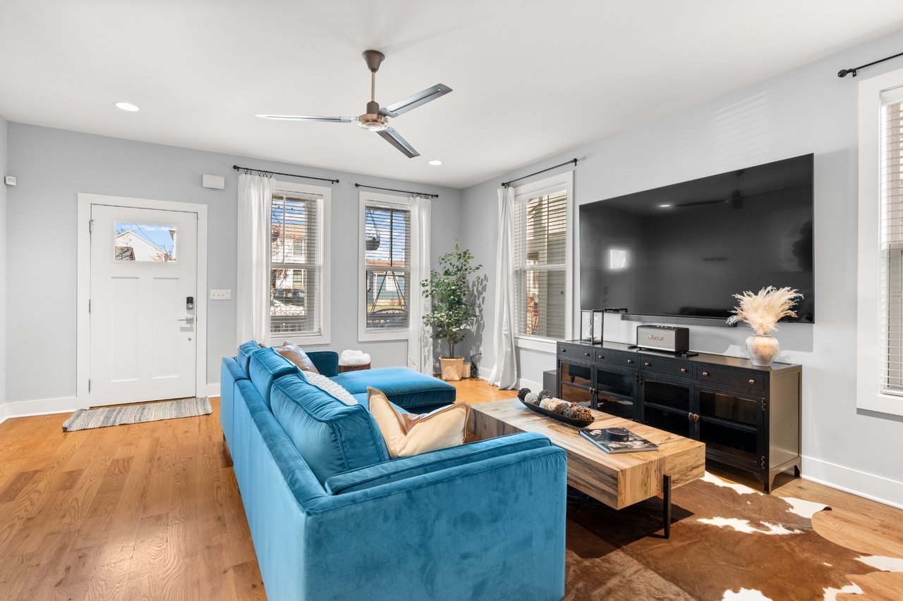 Dining area at 6117 California Ave #B — window and chandelier