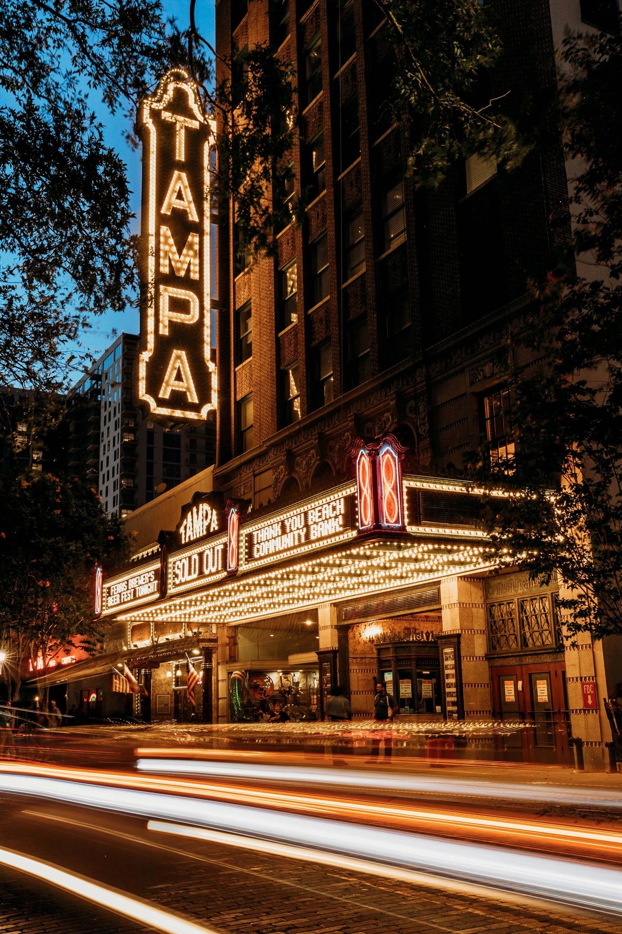 The historic Tampa Theatre illuminated at night in downtown Tampa, Florida, a legendary landmark known for its beautiful architecture and local ghost stories