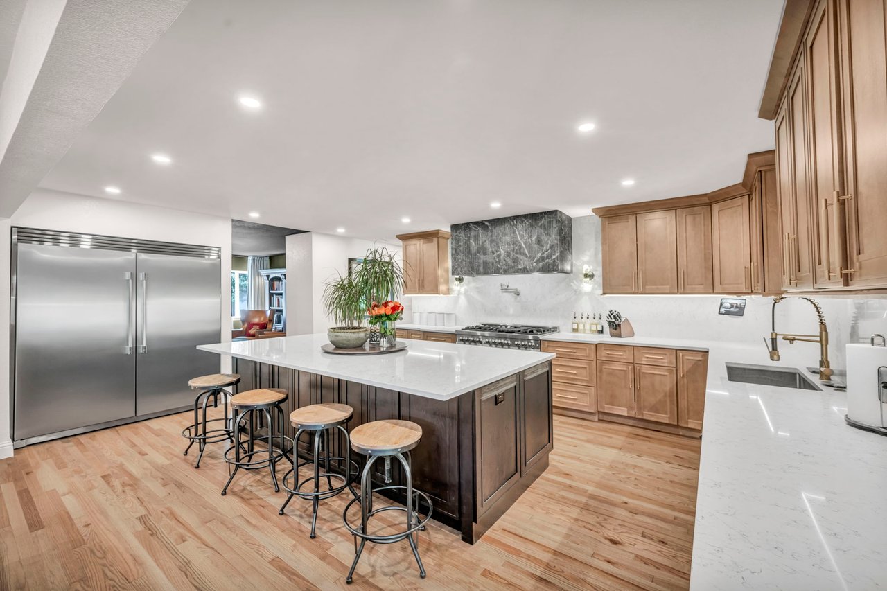 Luxury chef's kitchen with quartz backsplash and ZLINE dual-fuel range