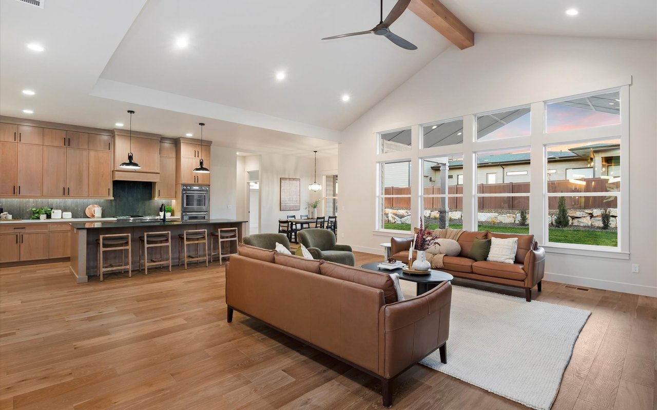 Great room with a bank of East-facing windows and gourmet kitchen