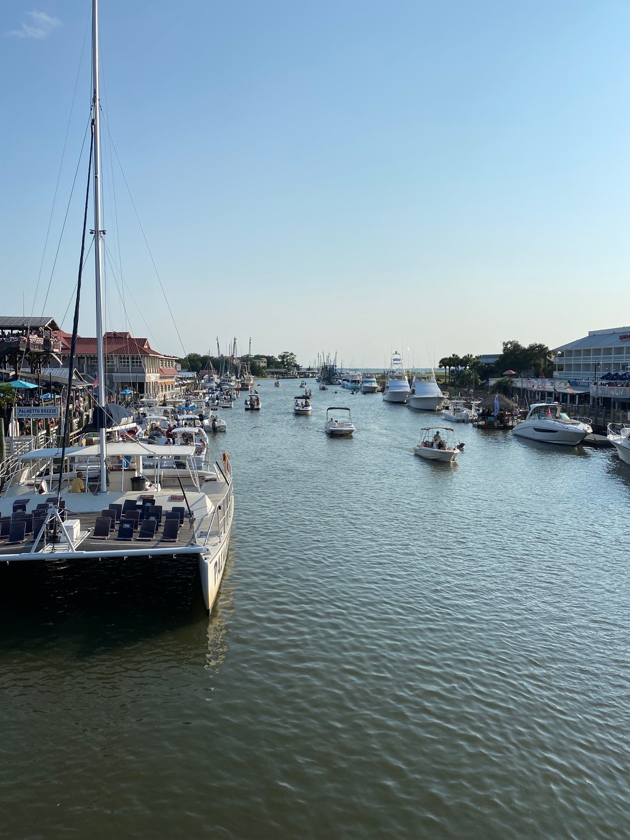 Shem Creek in Mount Pleasant, SC with boats and waterfront restaurants—coastal living at its finest