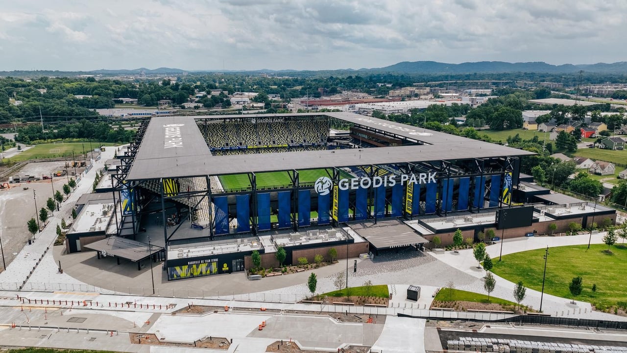 Aerial view of GEODIS Park, with its blue facade, open roof and surrounding Nashville development.