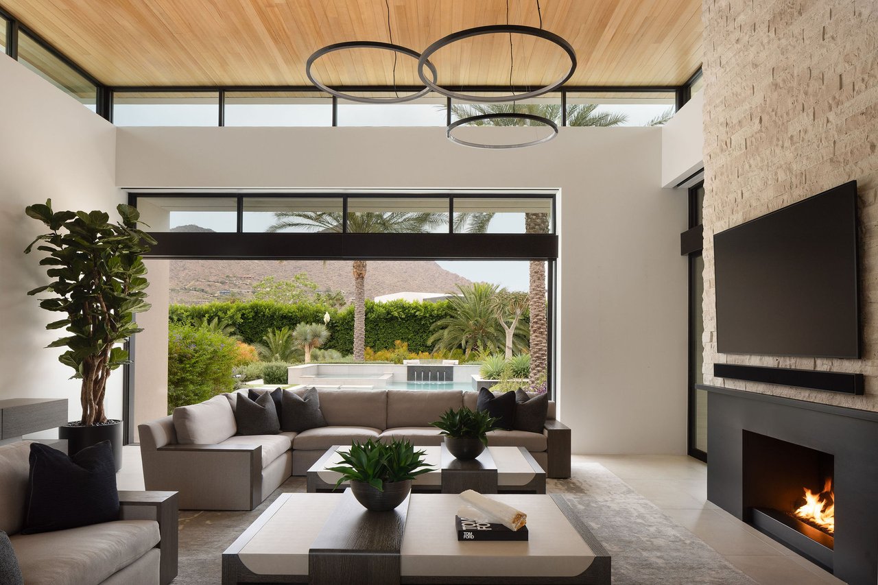 Modern luxury home in Paradise Valley with resort-style backyard, pool, fire feature, and contemporary architecture at sunset.