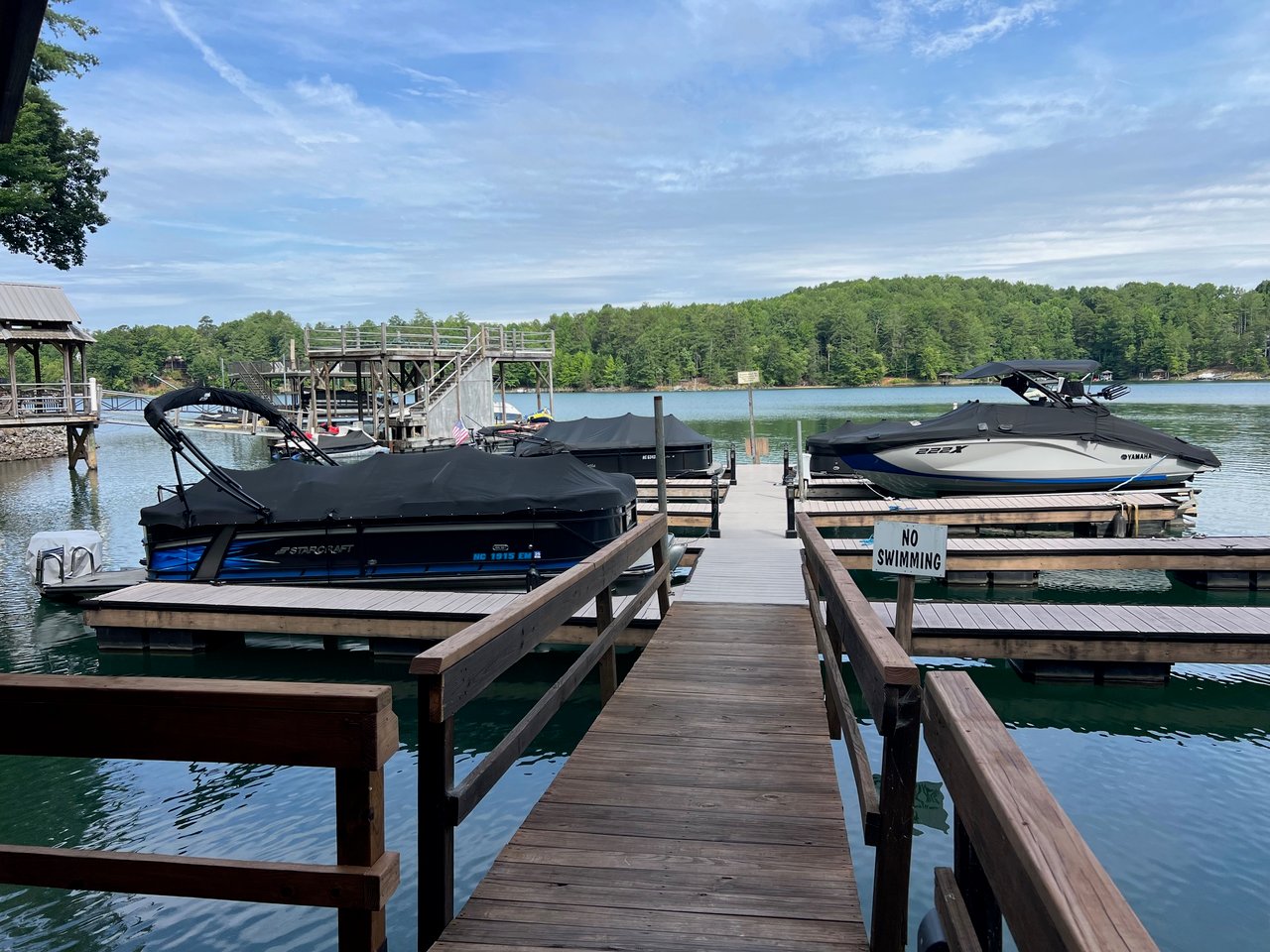 Lakefront vs. lake-access homes on Lake James, NC, comparing a waterfront home with private dock to a community lake-access boat launch.