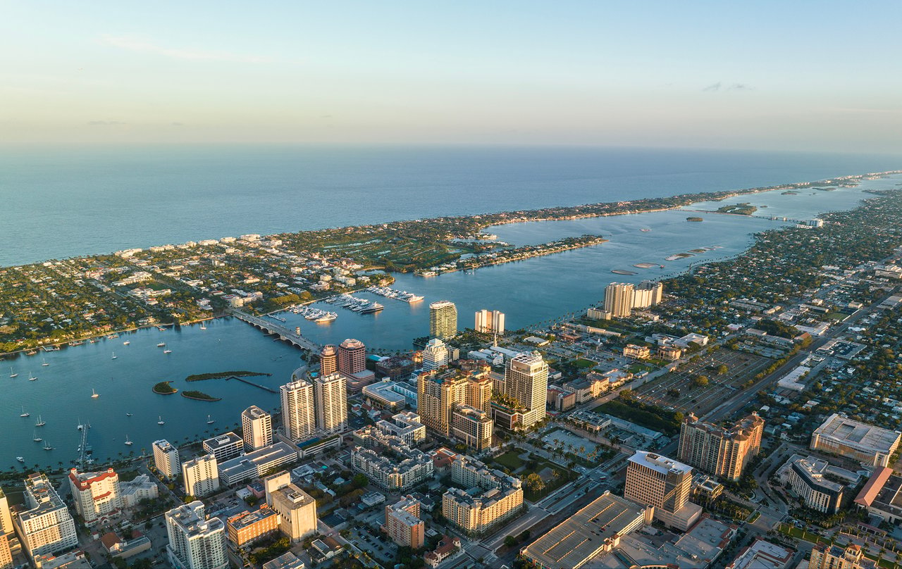 Aerial view of West Palm Beach waterfront, marina, bridge, and ocean.
