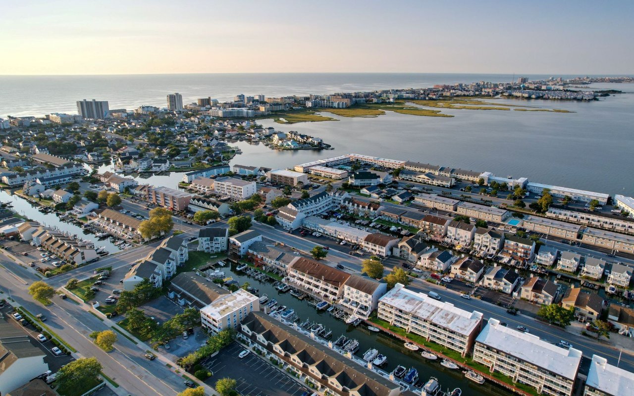 Aerial view of Ocean City waterfront homes, canals, and condominiums beside the bay and ocean.