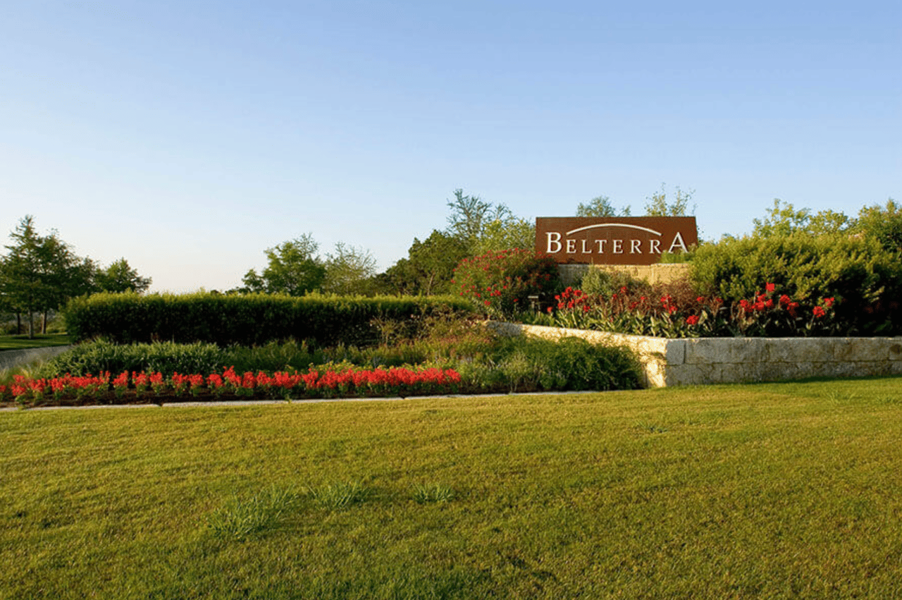 Belterra community entrance sign amid landscaped flower beds.