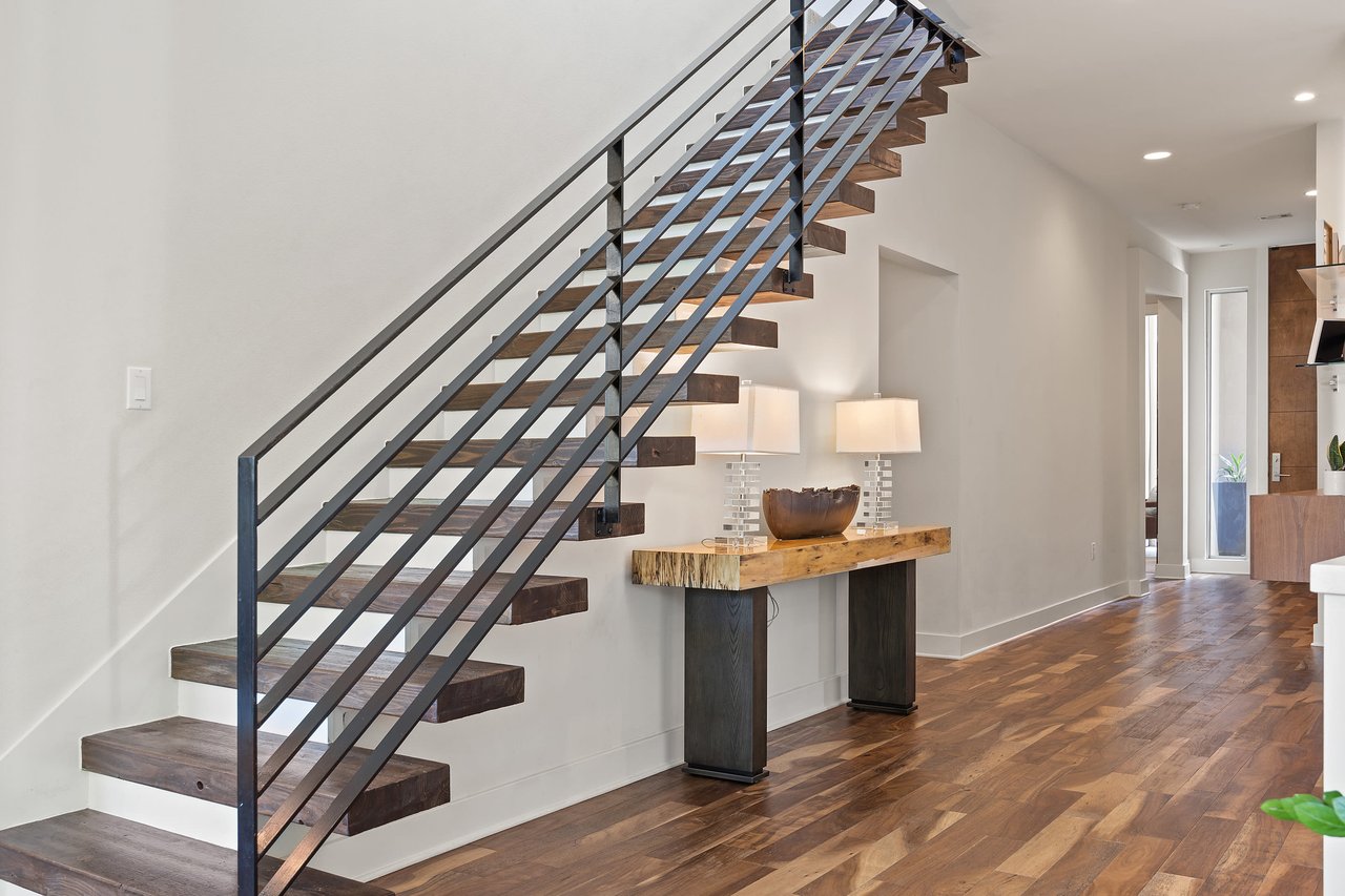Staircase with floating wood treads and cable railing at 34 Margranita Crescent, Tarrytown, Austin, TX.
