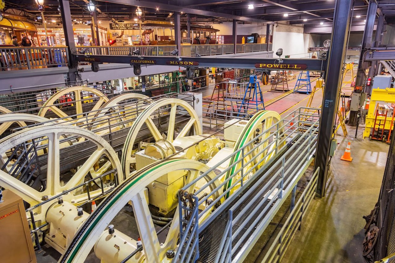 Cable car winding wheels and machinery on display inside San Francisco museum