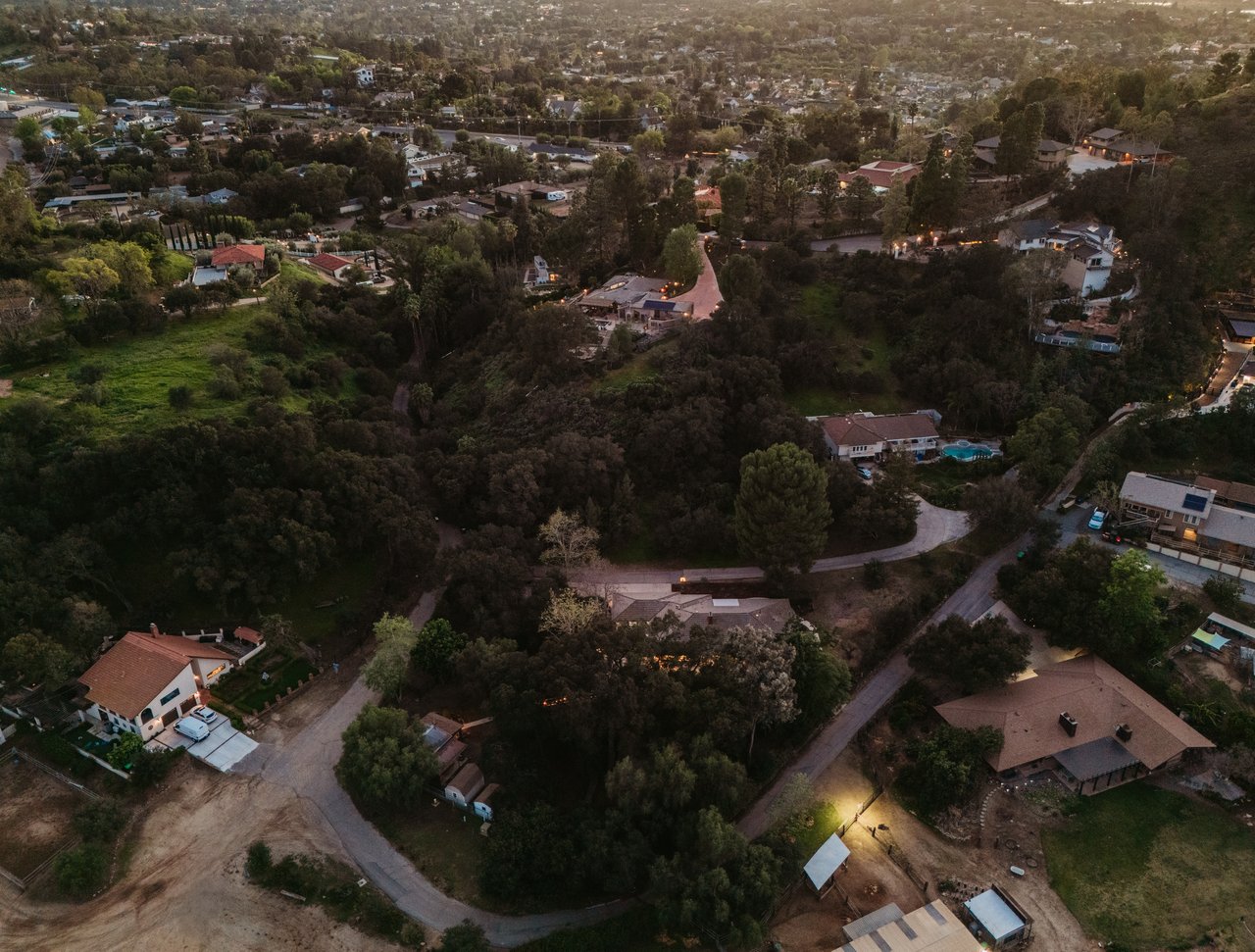 Aerial view of Orange Park Acres homes among wooded lots and winding roads.