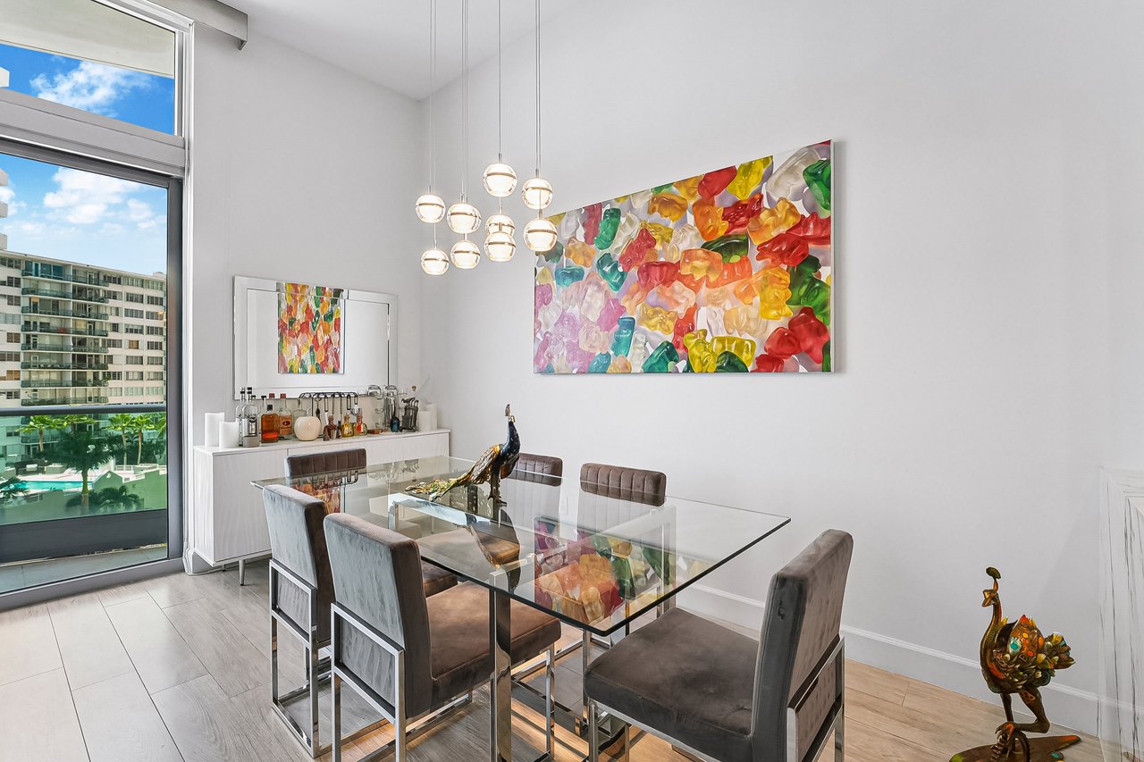 Separate dining area with high ceilings and floor-to-ceiling glass in Jade at Brickell Bay Unit 611
