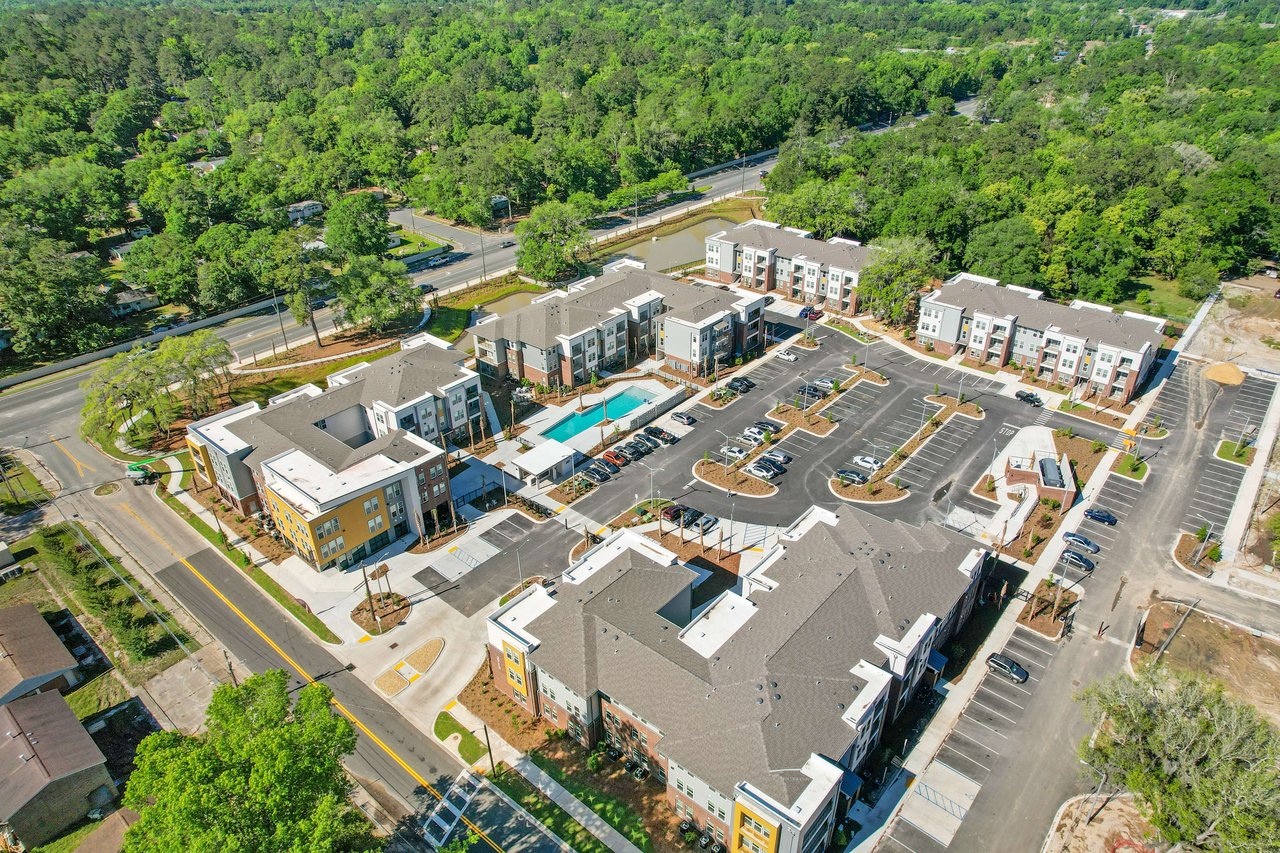 An aerial view of South City in a more dense setting with various buildings and parking areas.