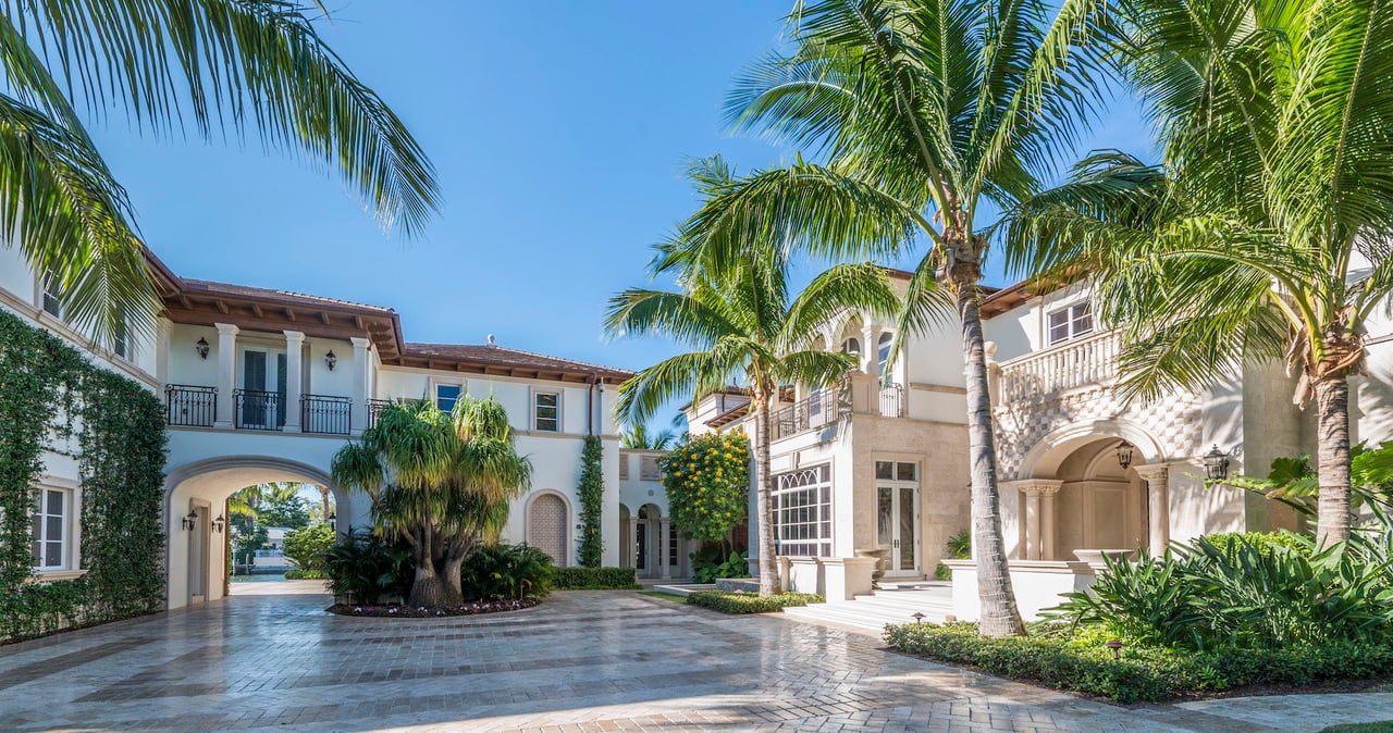 a large white mansion with driveway