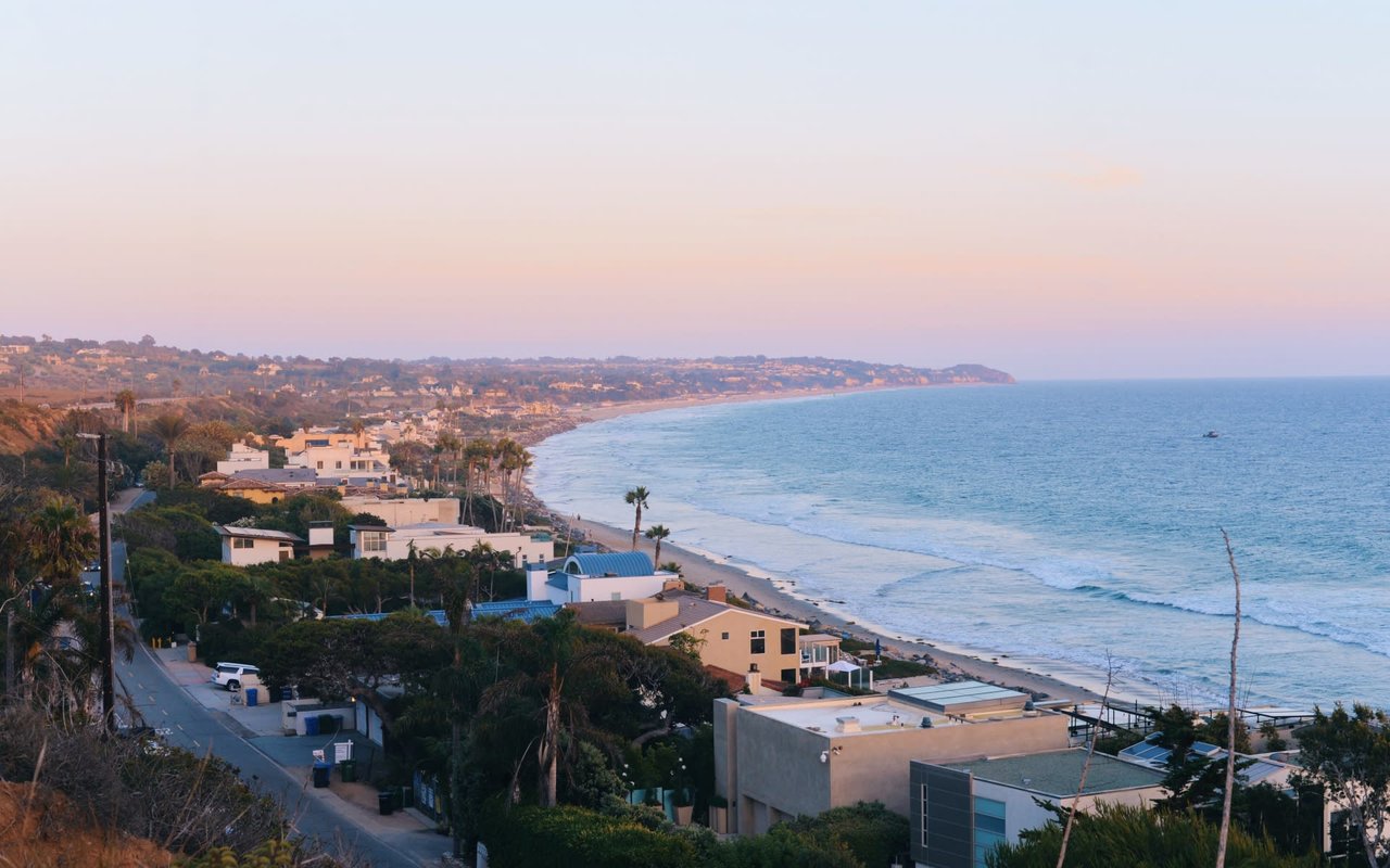 A photo of a beach community with houses near the shore.