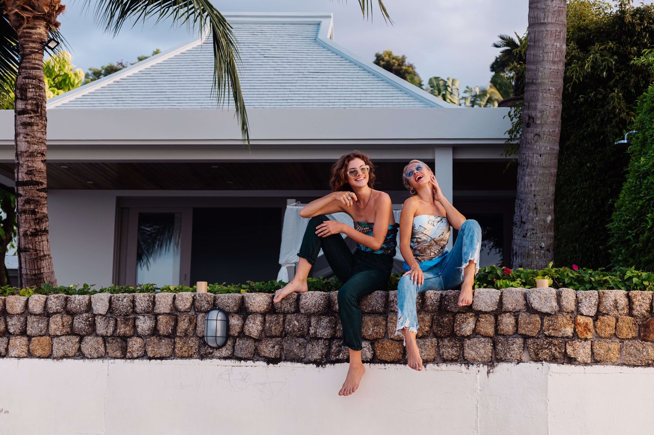 two happy people with sunglasses on vacation in a tropical country