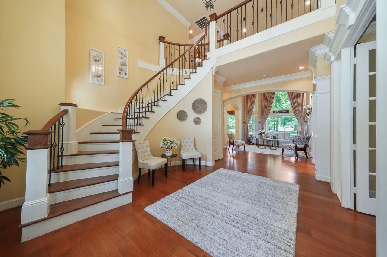 Cascading curved stairway greets you in the two-story formal entry. Study with french doors to the right.