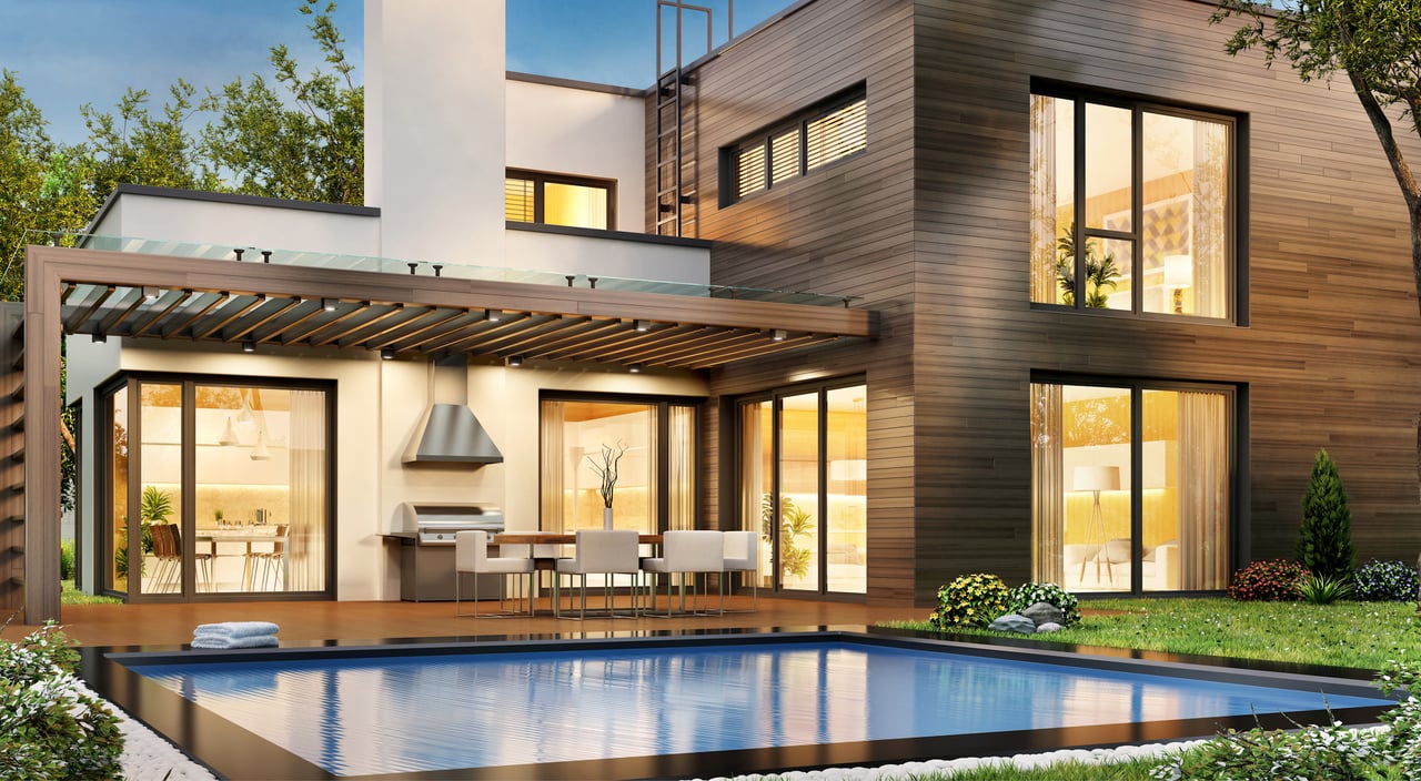 Modern wood-sided home with a glass-railed pergola, outdoor dining area, and swimming pool.