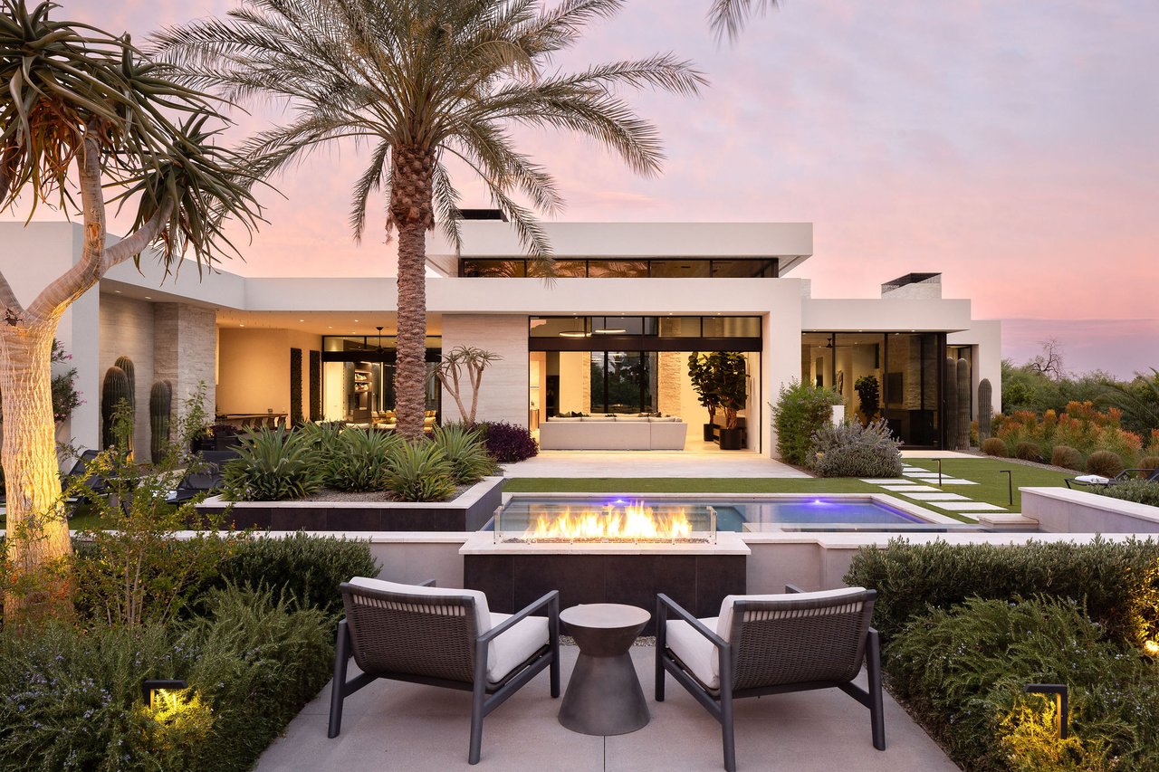 Modern luxury home in Paradise Valley with resort-style backyard, pool, fire feature, and contemporary architecture at sunset.