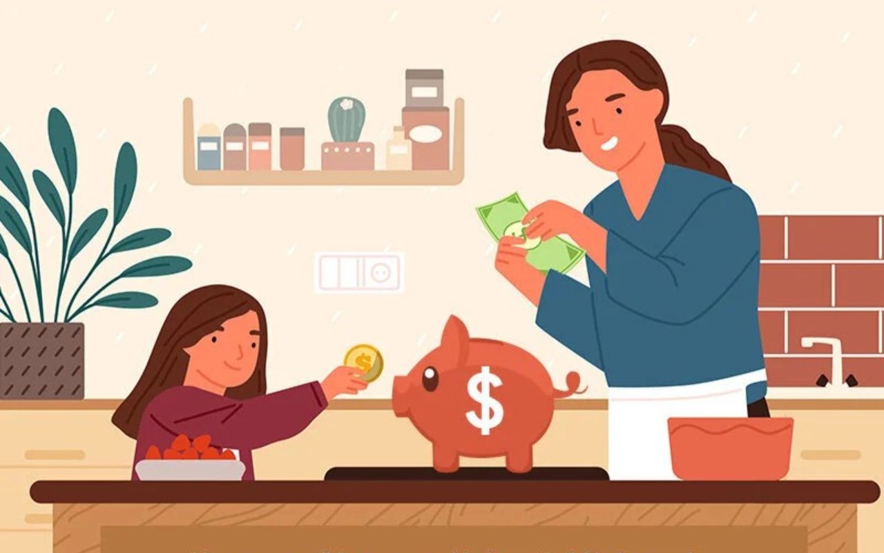A woman counts bills as a child adds a coin to a piggy bank in the kitchen.
