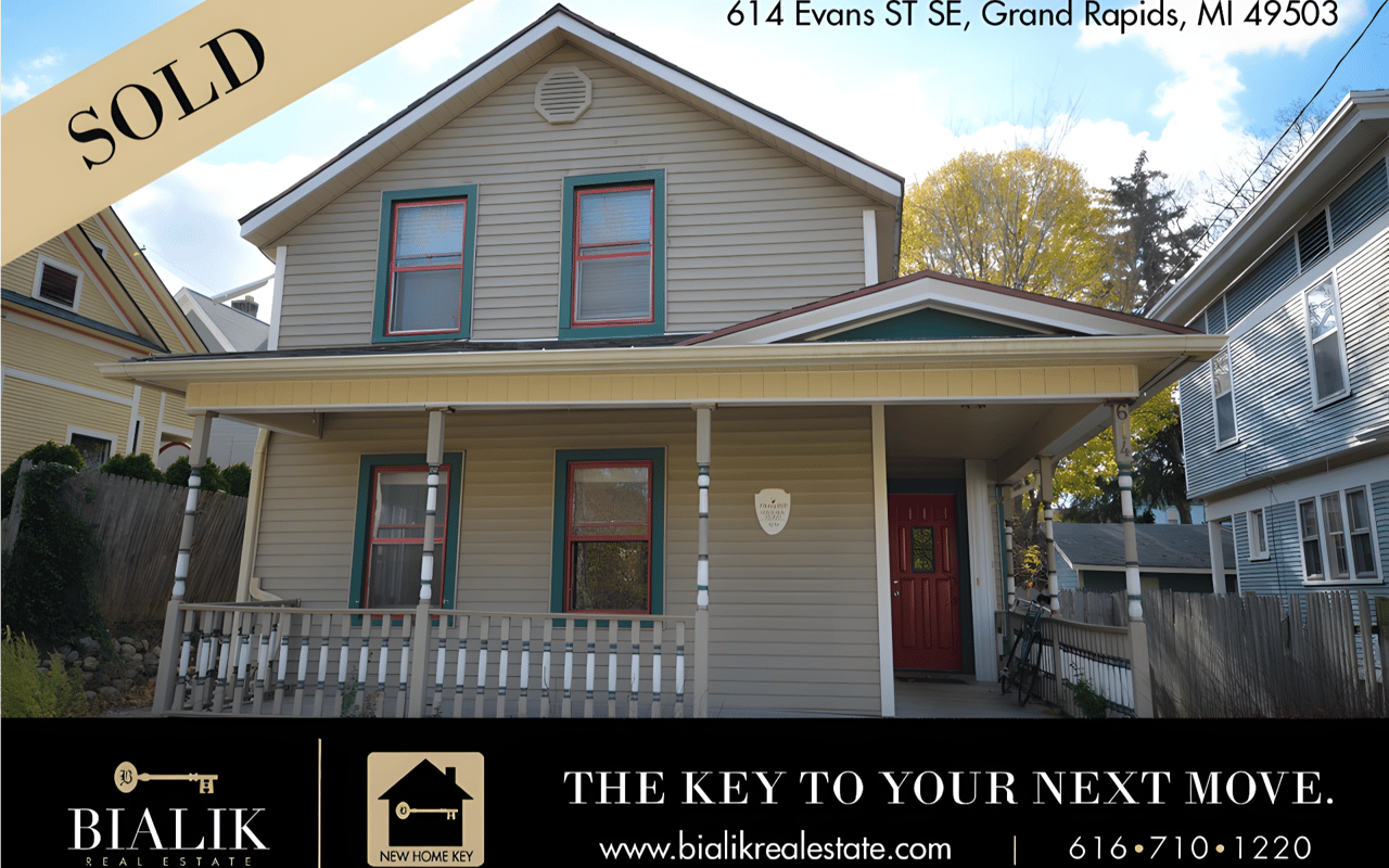 Promotional graphic for a sold two-story home at 614 Evans ST SE, with a covered porch and red front door.