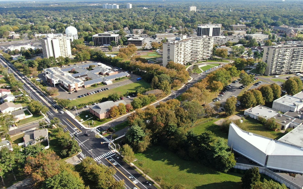 Aerial view of Cherry Hill with apartment towers and tree-lined streets.