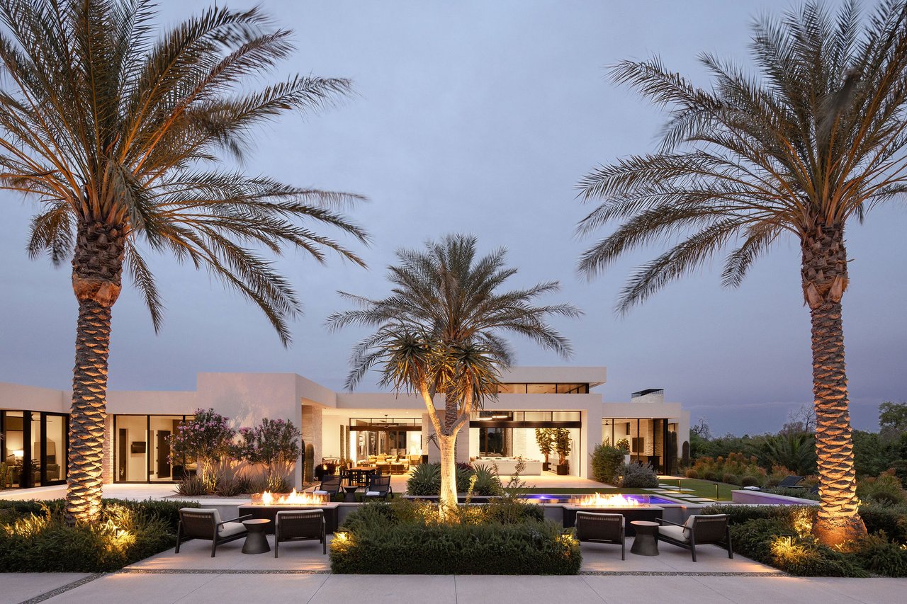 Modern luxury home in Paradise Valley with resort-style backyard, pool, fire feature, and contemporary architecture at sunset.