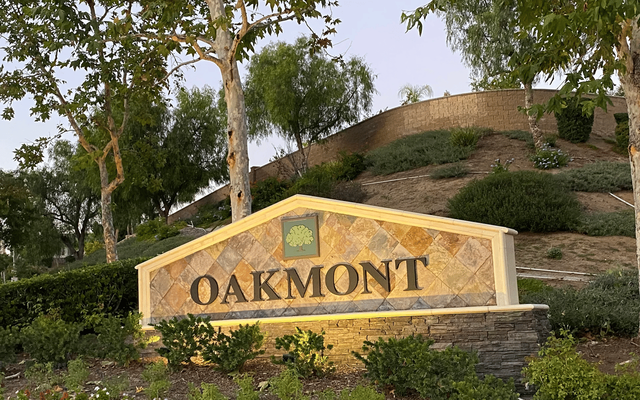 Stone entry monument sign surrounded by landscaping for the Oakmont neighborhood in Wildomar, CA.