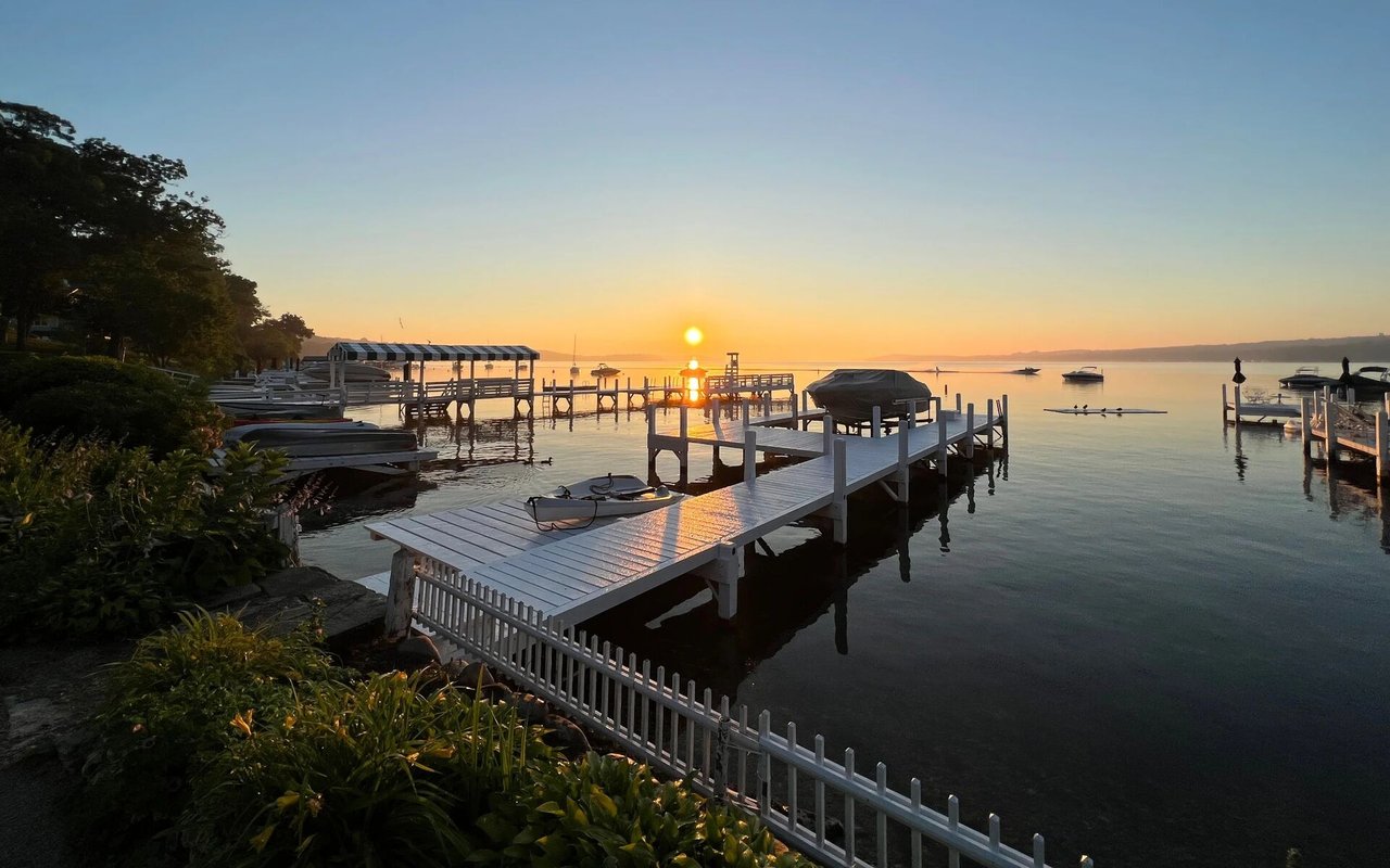 Waterfront docks and moored boats at sunset.
