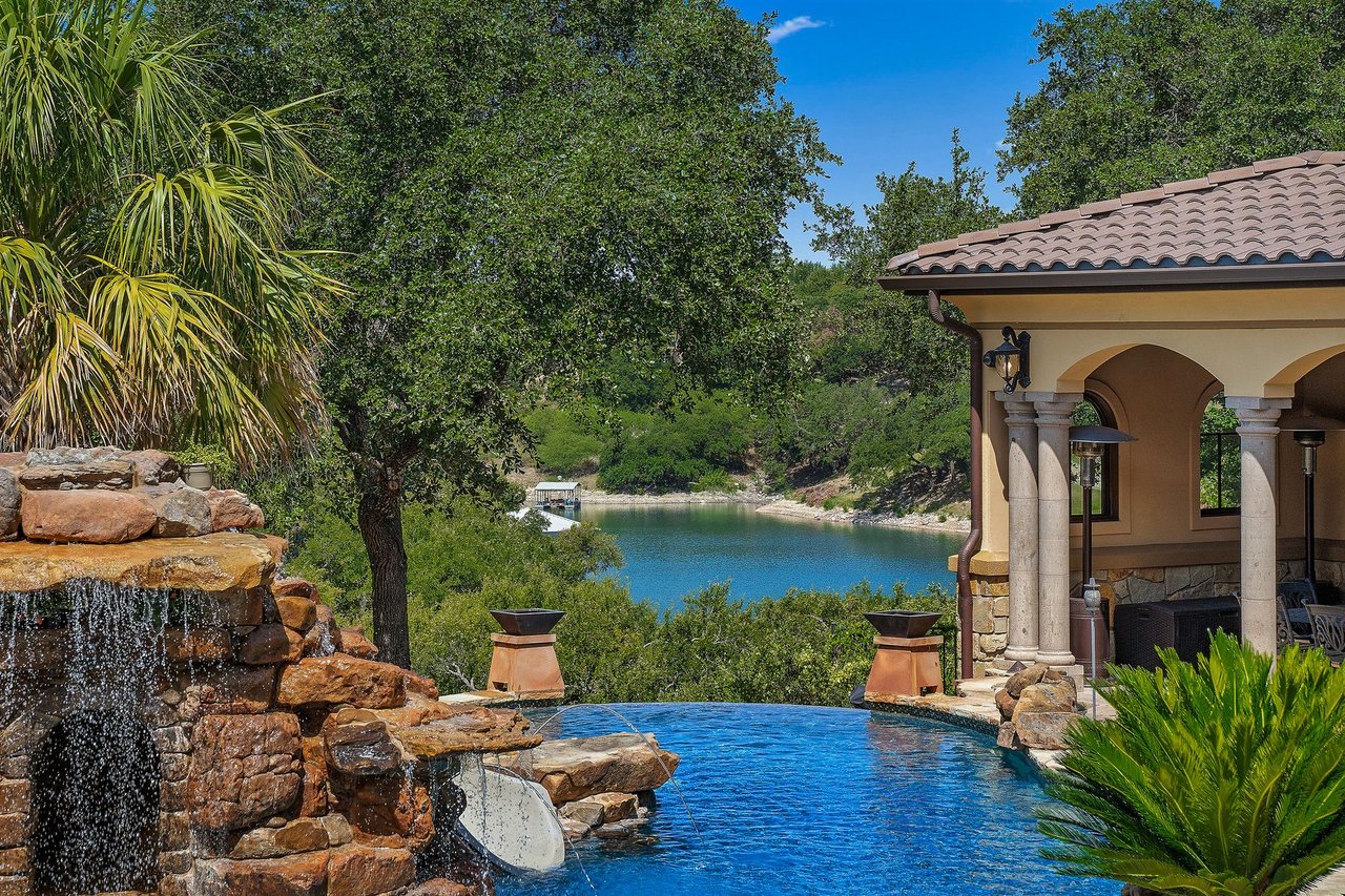 Covered patio overlooking a stacked stone waterfall and the Lake Travis cove at 25715 Cliff Circle, Lakecliff on Lake Travis, Spicewood, Texas.