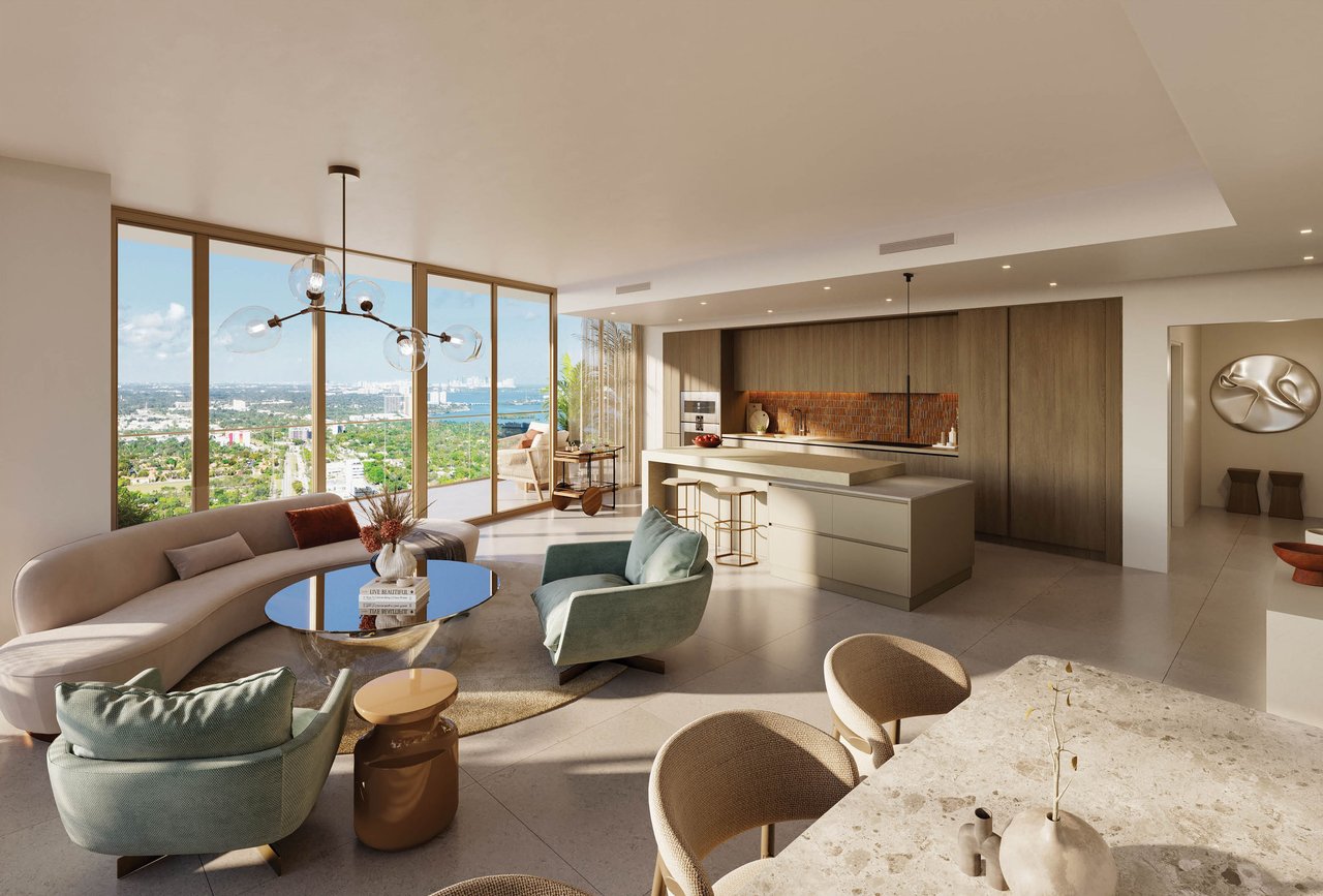 Open-plan condo living room and kitchen with floor-to-ceiling windows overlooking Miami’s cityscape and water.