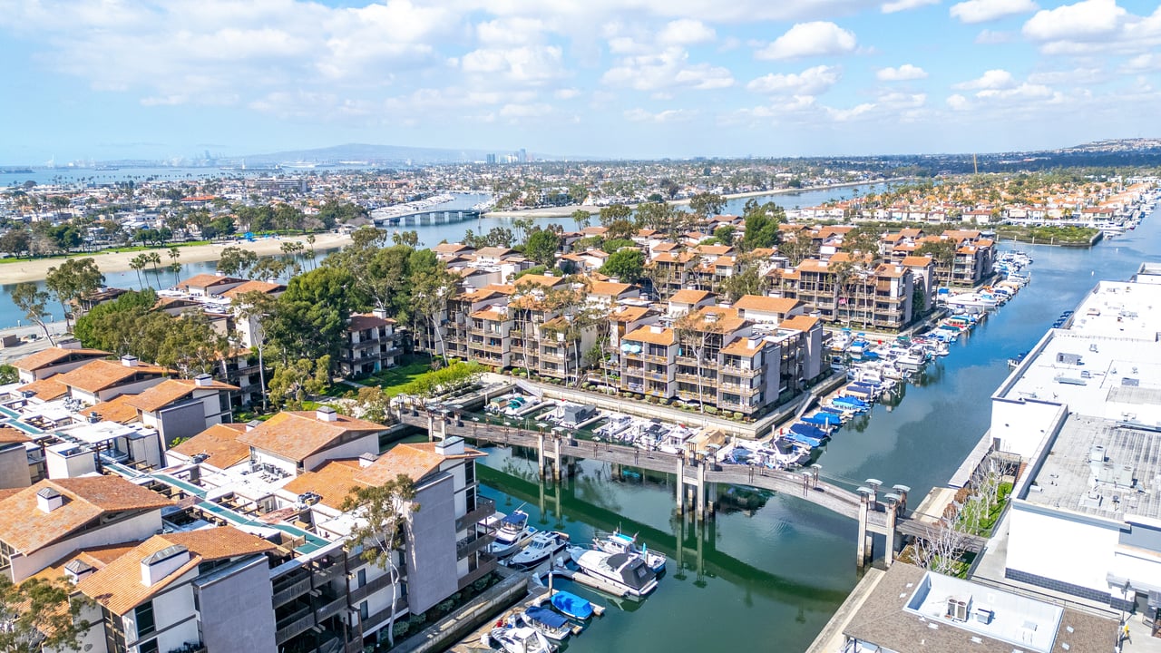 Aerial view of Marina Pacifica condos along Alamitos Bay in Long Beach CA with bridges and waterfront buildings