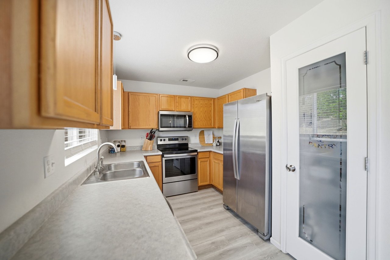 Kitchen with walk-in pantry, stainless dishwasher, microwave, range/oven and set adjacent dining area