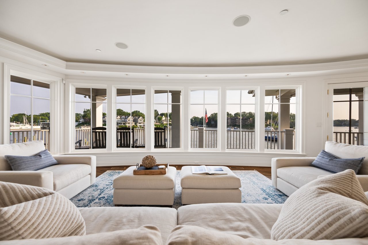 A living room with subtle linens and textures looking over the water onto Spa Creek in Annapolis, MD