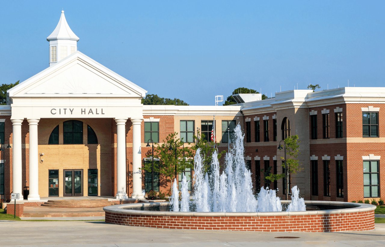 East Point City Hall and its circular fountain on a sunny day.