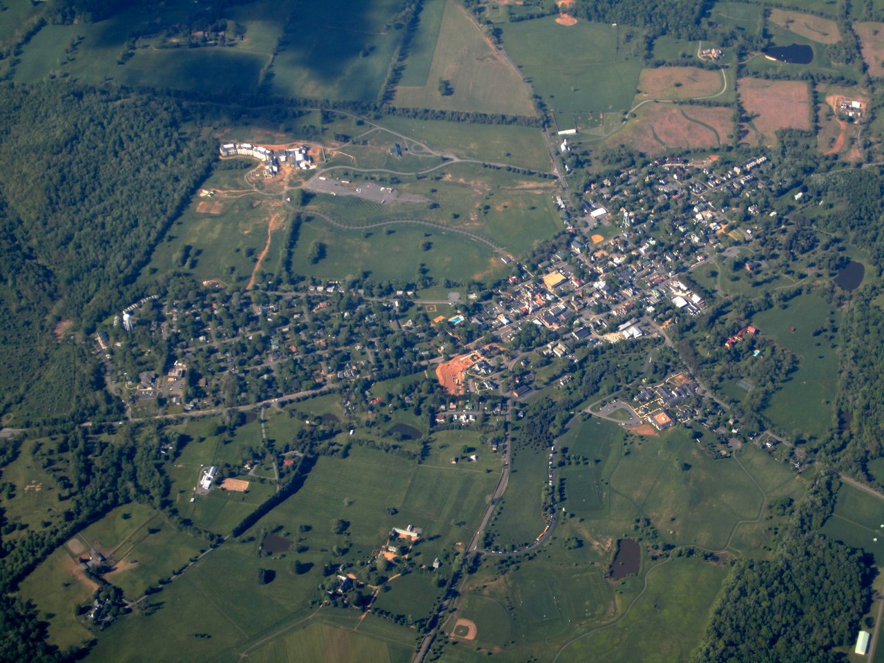 Aerial view of Middleburg surrounded by farmland and wooded areas.