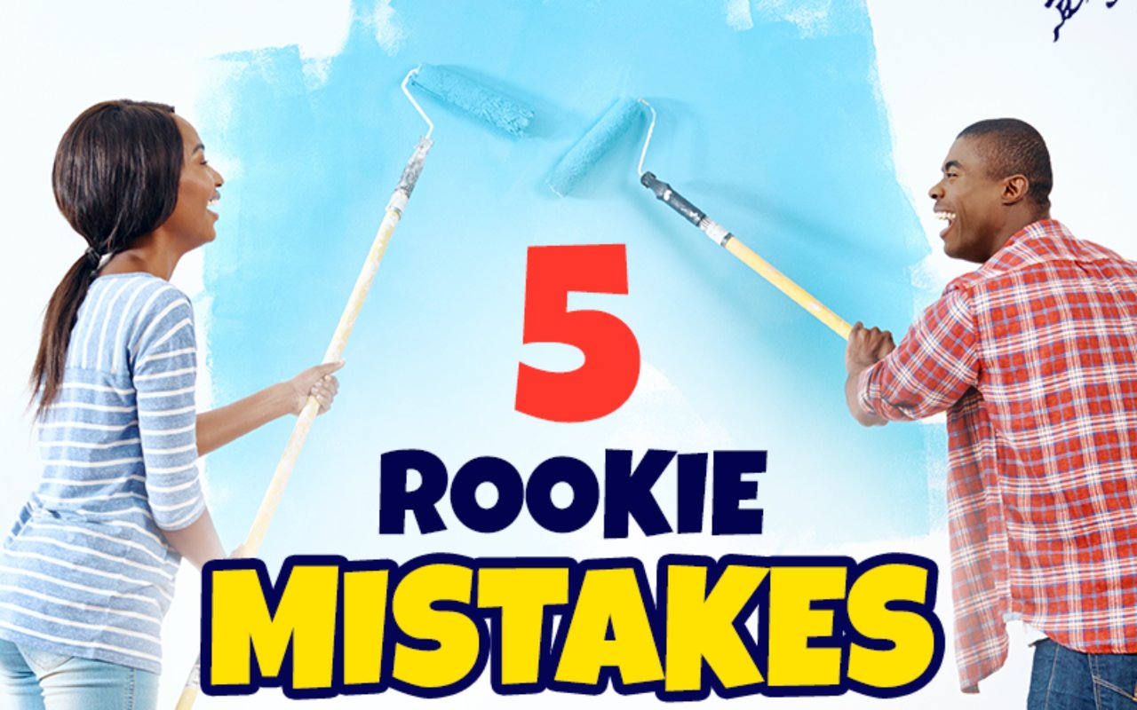 5 rookie mistakes: a woman and man paint a wall blue with rollers.