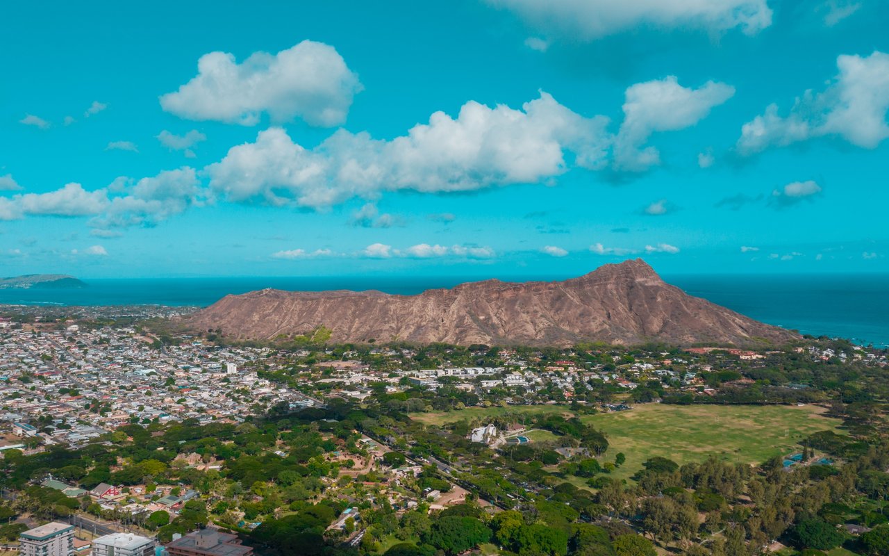 Honolulu homes spread below Diamond Head, with the Pacific Ocean in the distance.