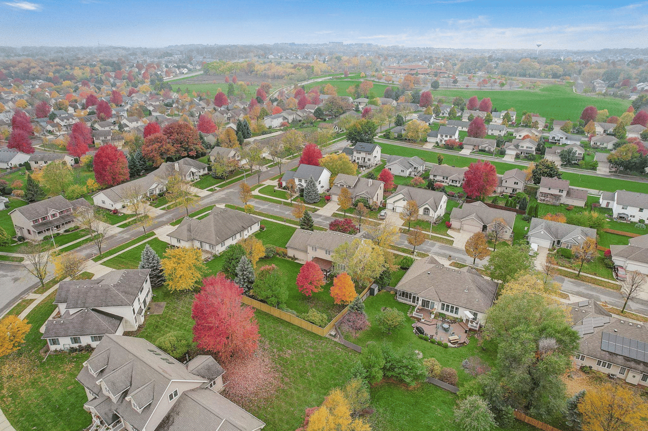 A colorful autumn aerial view of a vibrant Madison, Wisconsin neighborhood, illustrating the diverse residential areas and community-focused lifestyle available in the 2026 Madison real estate market.
